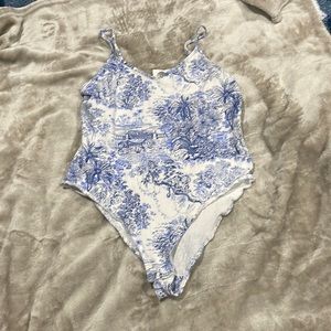 blue patterned body suit